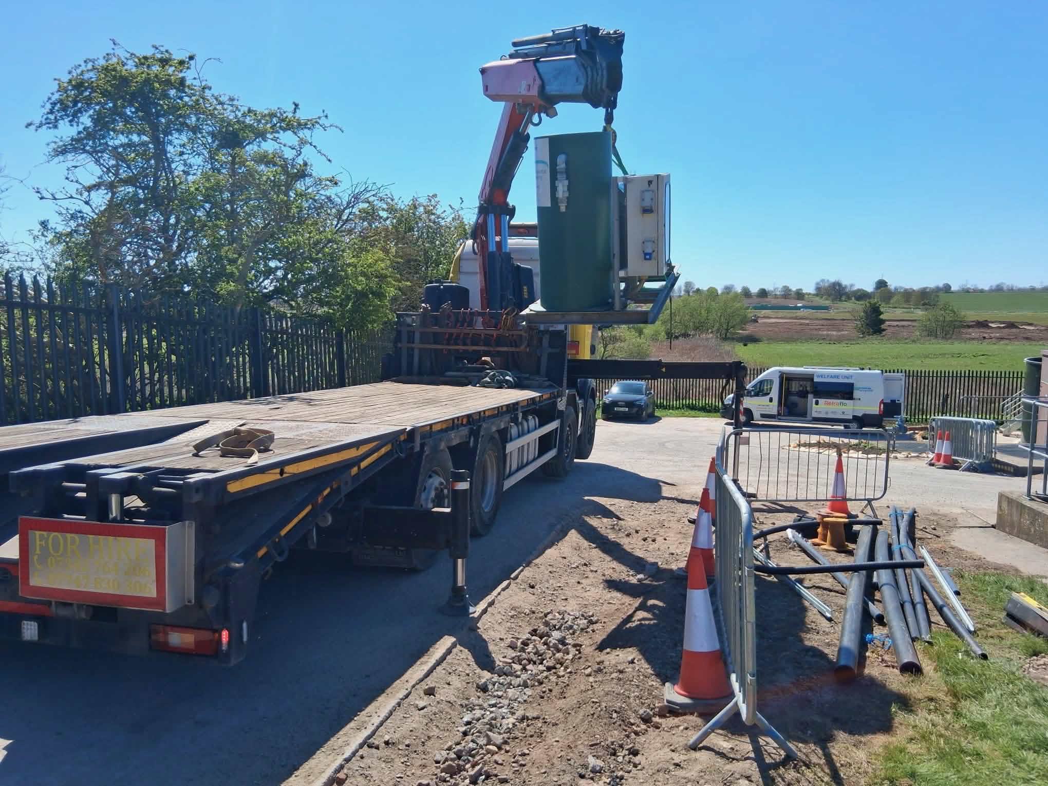 HIAB crane lifting electrical cabinet on site