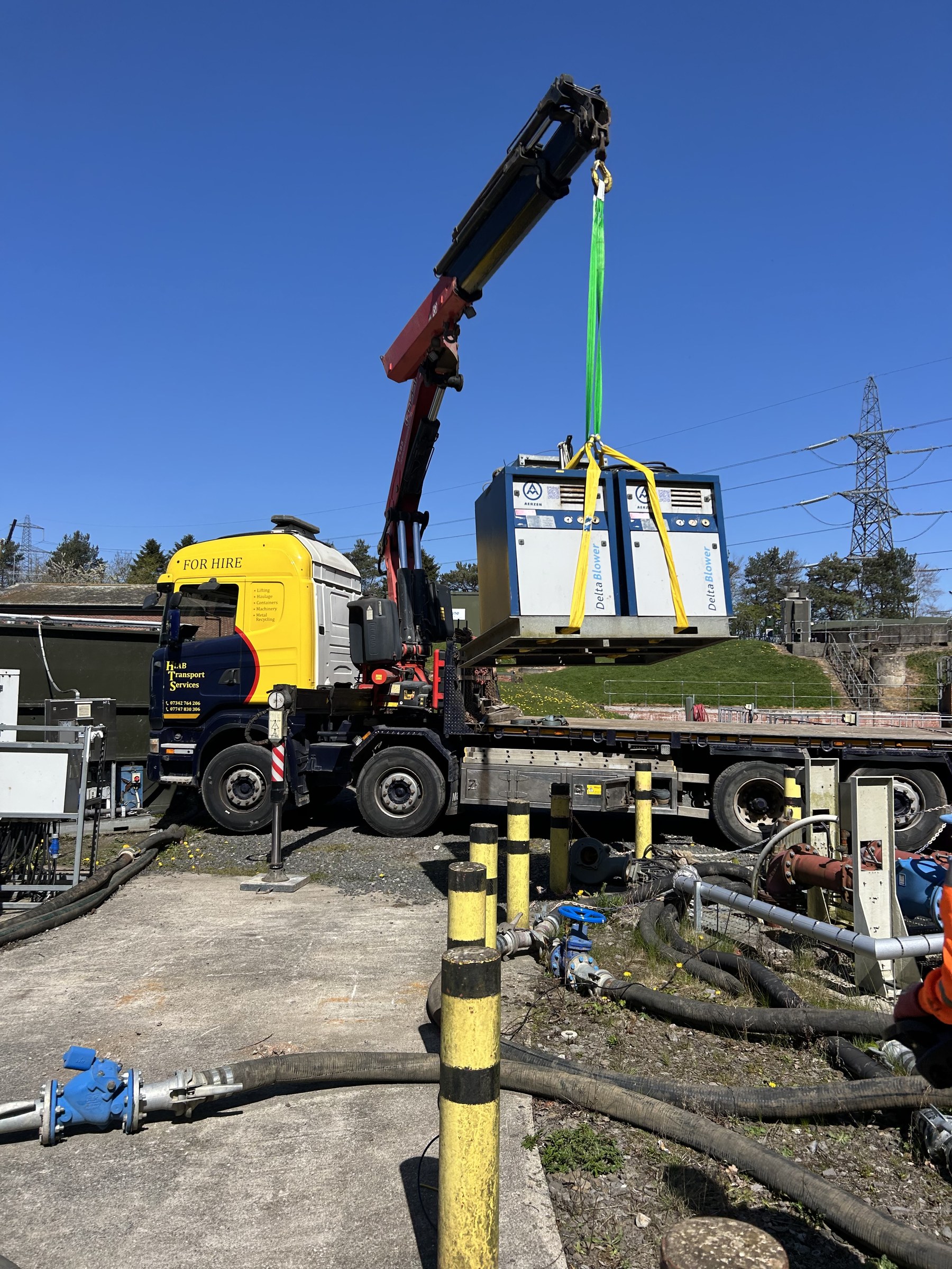 HIAB crane lifting electrical cabinet on site
